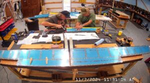 EA: Page 9-17 Step 8. Rivet Trim Tab Horns & Lower Spar Flange To Skins.