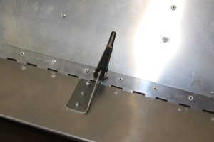 Trim tab rod end attached to horn with check paint / paste on stop nut.