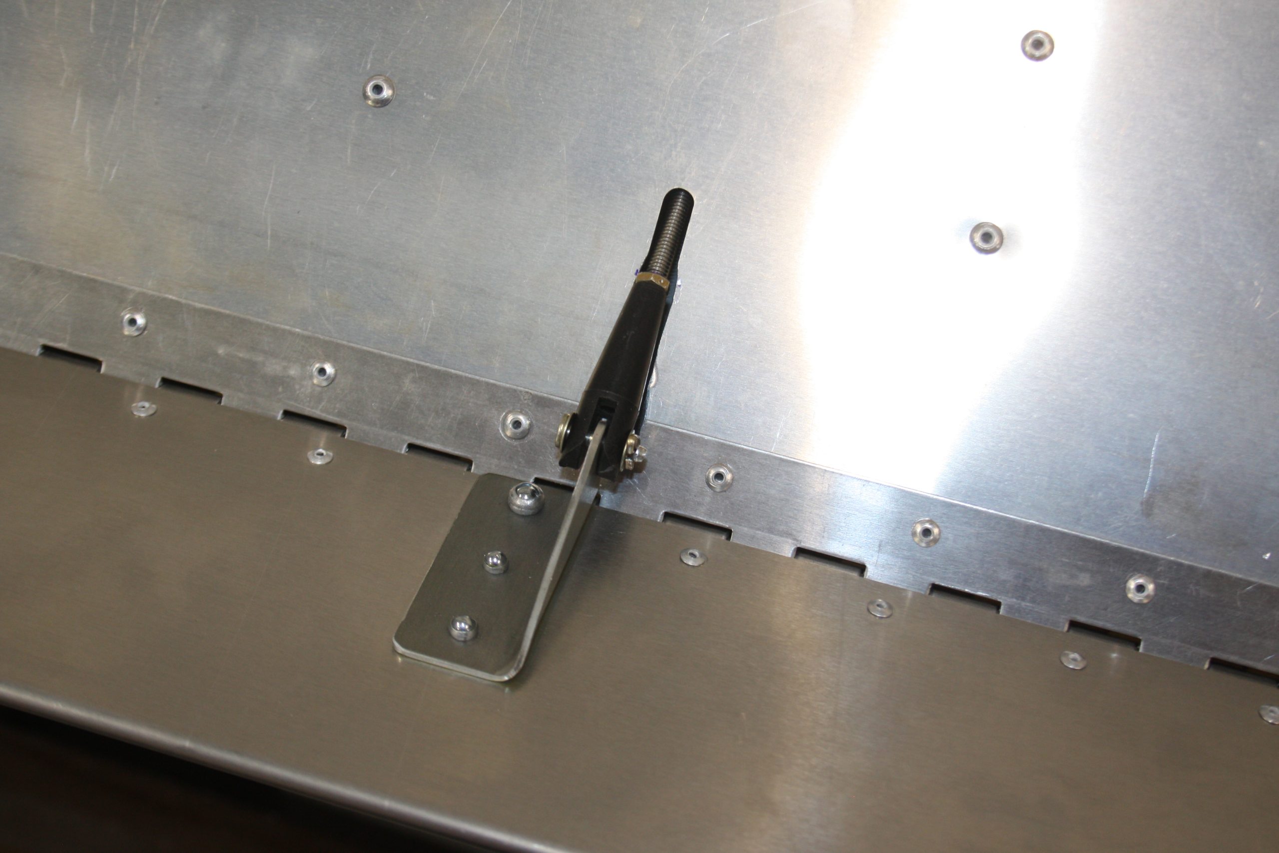 Trim tab rod end attached to horn with check paint / paste on stop nut.