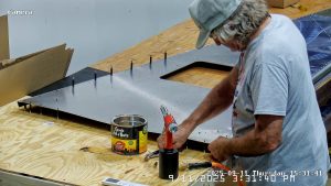 Riveting the forward bottom fuselage skin and gussets