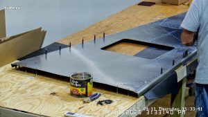 Riveting the forward bottom fuselage skin and gussets