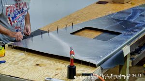 Riveting the forward bottom fuselage skin and gussets