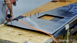 Riveting the forward bottom fuselage skin and gussets
