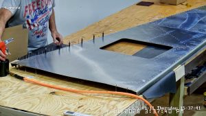 Riveting the forward bottom fuselage skin and gussets