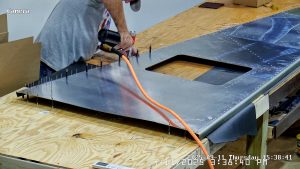 Riveting the forward bottom fuselage skin and gussets
