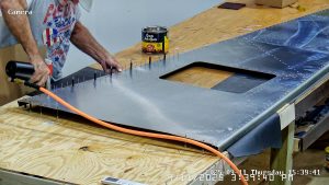 Riveting the forward bottom fuselage skin and gussets