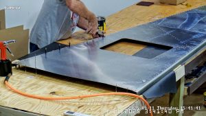 Riveting the forward bottom fuselage skin and gussets