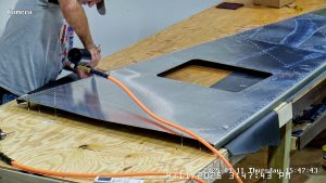 Riveting the forward bottom fuselage skin and gussets