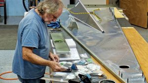 Assembling the torque tube bearing and cable fairleads onto the jump seat front and rear channels