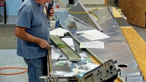 Assembling the torque tube bearing and cable fairleads onto the jump seat front and rear channels