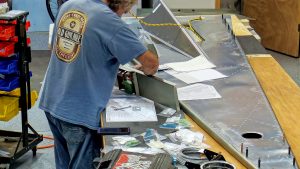 Assembling the torque tube bearing and cable fairleads onto the jump seat front and rear channels