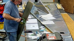 Assembling the torque tube bearing and cable fairleads onto the jump seat front and rear channels