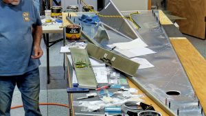 Assembling the torque tube bearing and cable fairleads onto the jump seat front and rear channels