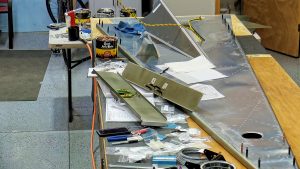 Assembling the torque tube bearing and cable fairleads onto the jump seat front and rear channels