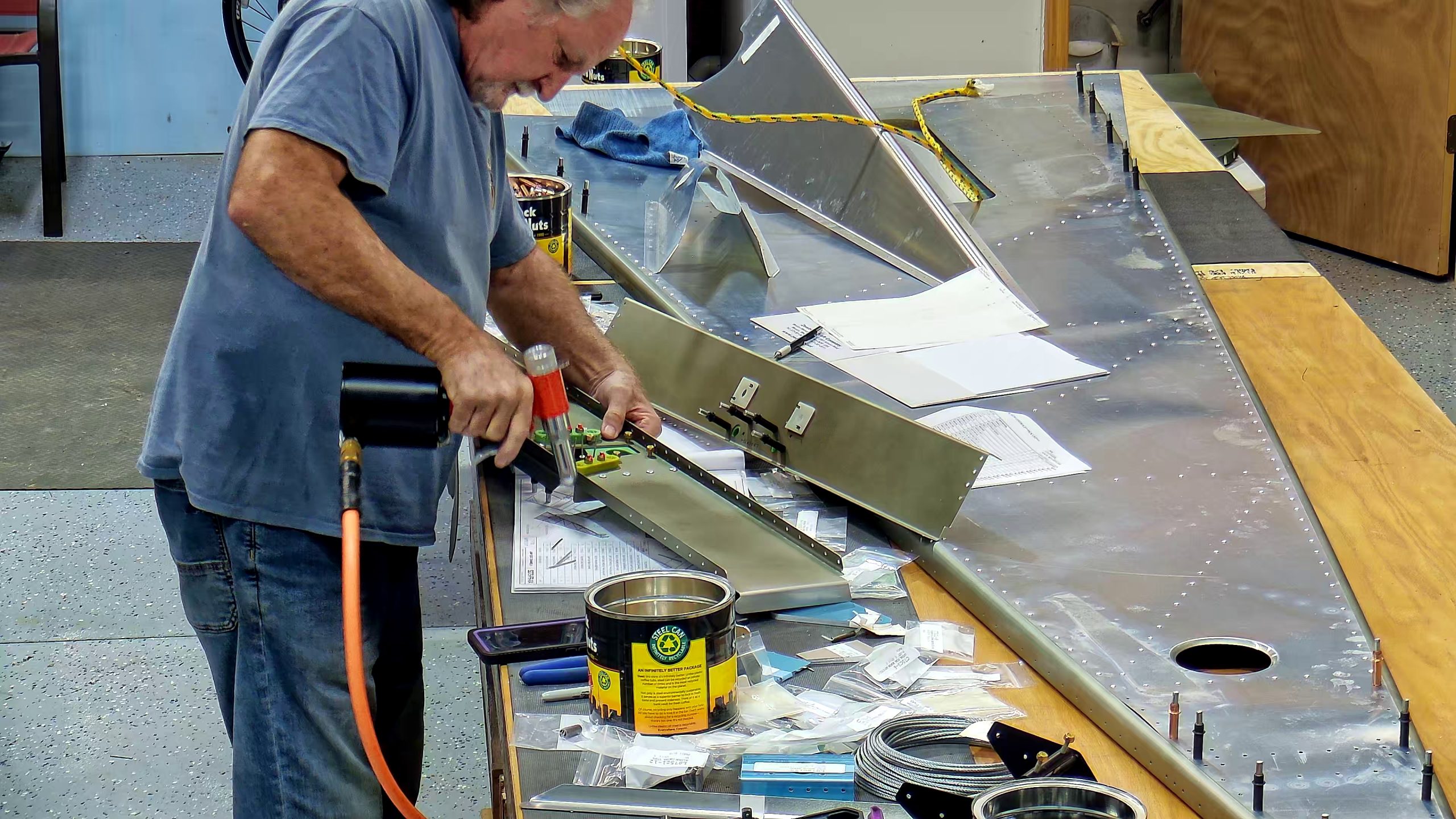 Assembling the torque tube bearing and cable fairleads onto the jump seat front and rear channels