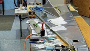 Assembling the torque tube bearing and cable fairleads onto the jump seat front and rear channels