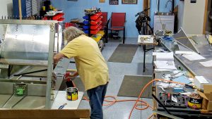 Riveting the side channels of the 750 SD baggage back to the side skins.